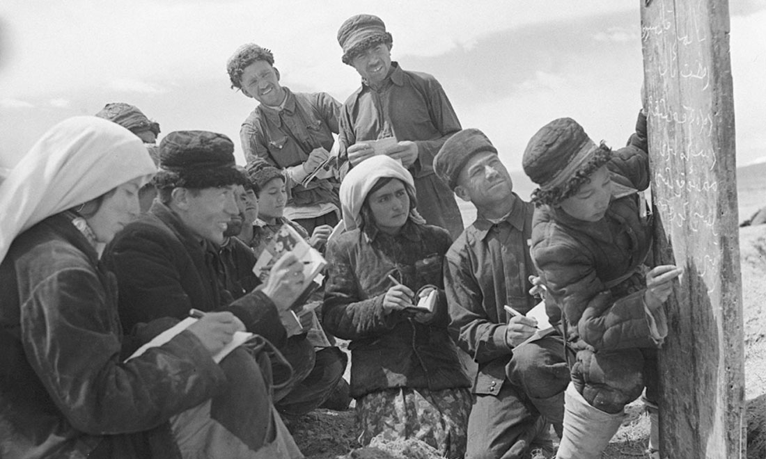 1960年6月，新疆慕士塔格峰下，大人們在小學(xué)生幫助下學(xué)習(xí)文化。新華社記者武純展攝
